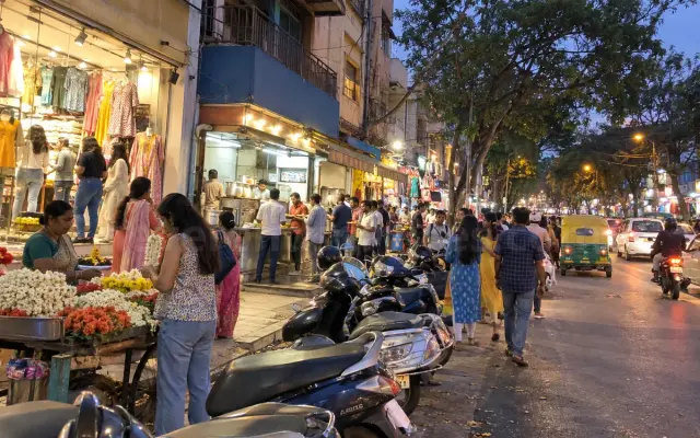 Flower seller and shoppers at Jayanagar 4th Block in the evening