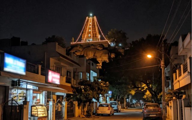 Call girls area JP Nagar — hilltop temple and residential street at night