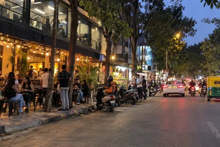 Cafes and a young crowd on 27th Main Road, HSR Layout, in the evening