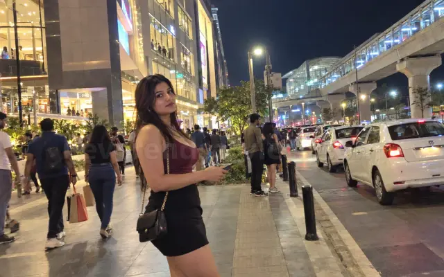 Woman in a maroon top outside a Whitefield mall near the metro