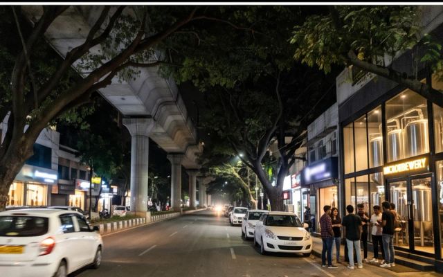 Call girls area Indiranagar — metro line and pub street at night