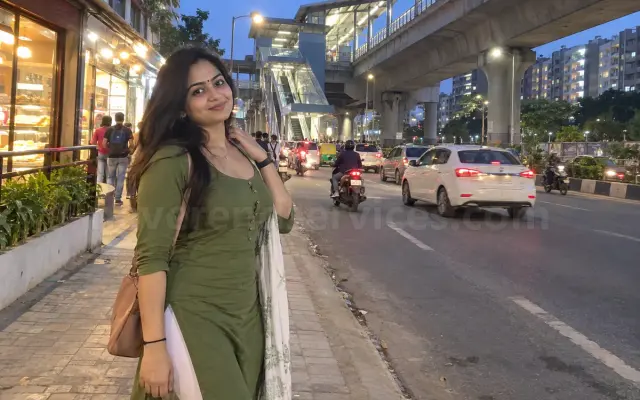 Woman in a green kurti near a metro station on Kanakapura Road
