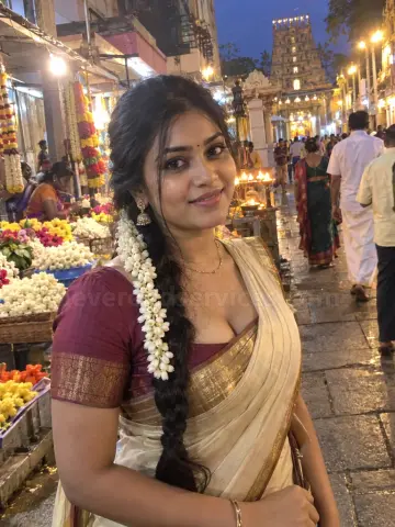 South Indian woman with jasmine in her braid near a temple market