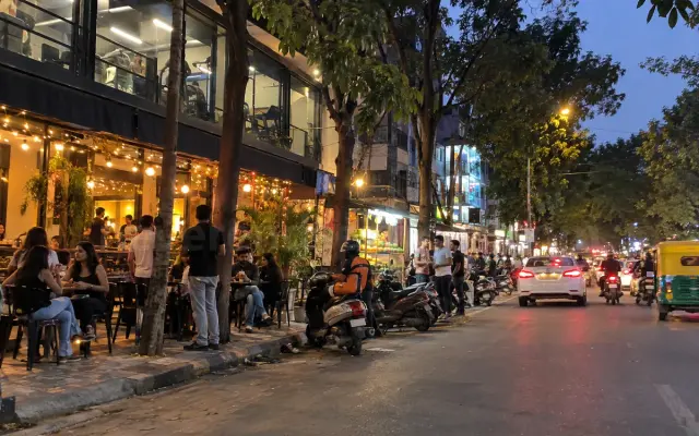 Cafes and a young crowd on 27th Main Road, HSR Layout, in the evening