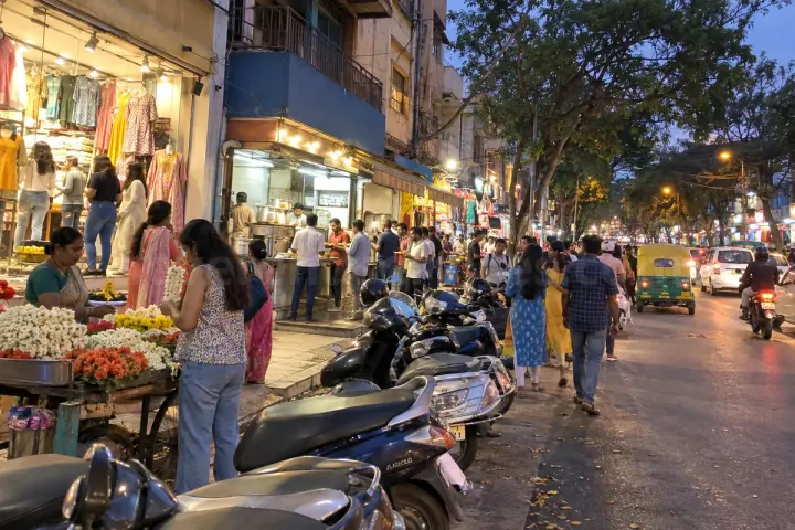 Flower seller and shoppers at Jayanagar 4th Block in the evening
